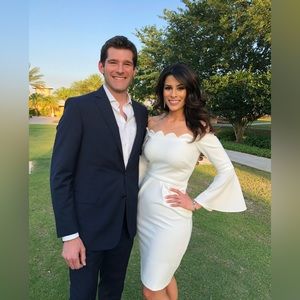 White scalloped aqua cocktail dress with bell sleeves.